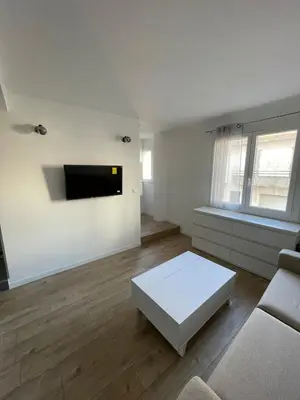 a living room with a couch and a tv on the wall at Beautiful Studio in Cannes, near beach and Croisette in Cannes