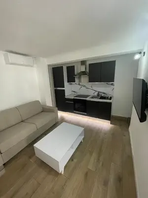 a living room with a couch and a table at Beautiful Studio in Cannes, near beach and Croisette in Cannes