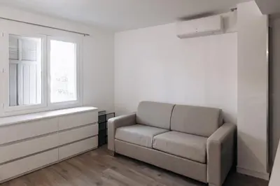 a living room with a couch and a window at Beautiful Studio in Cannes, near beach and Croisette in Cannes