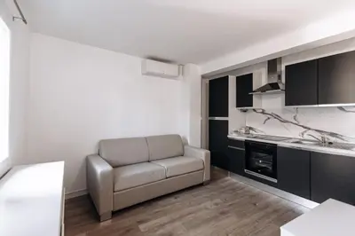 a living room with a couch and a kitchen at Beautiful Studio in Cannes, near beach and Croisette in Cannes