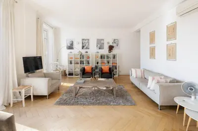 a living room with a couch and a table at Center of Cannes 100m2 bright apartment in Cannes