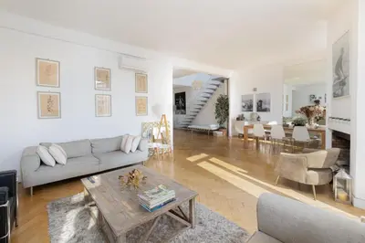 a living room with a couch and a table at Center of Cannes 100m2 bright apartment in Cannes