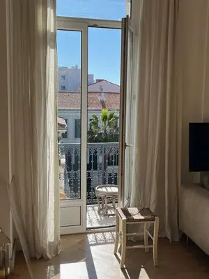 a living room with a sliding glass door with a view at Center of Cannes 100m2 bright apartment in Cannes