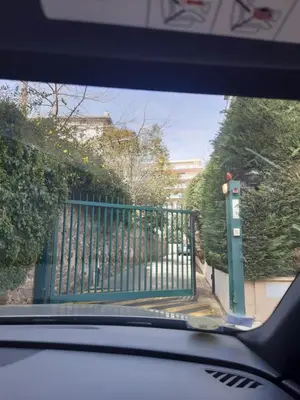 a car looking through a car window at a gate at Appartement jardin in Cannes