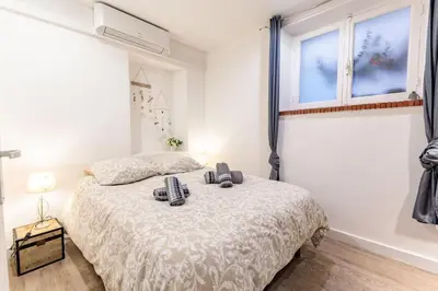 a bedroom with a bed and a window at Sublime Appartement 5 Mins à Pied Du Palais Des Festivals by Halldis in Cannes