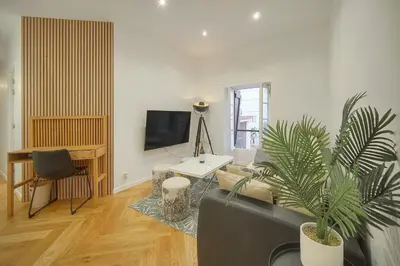 a living room with a couch and a tv at Charmant 2 pièces -square MISTRAL -proche Plages DU MIDI A1B266 in Cannes