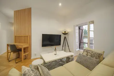 a living room with a couch and a table at Charmant 2 pièces -square MISTRAL -proche Plages DU MIDI A1B266 in Cannes