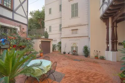 a courtyard with a table and chairs in a building at Charmant 2 pièces -square MISTRAL -proche Plages DU MIDI A1B266 in Cannes