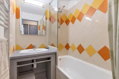 a bathroom with a sink and a tub and a mirror at Family Sea view with pools near shops and beaches in Cannes