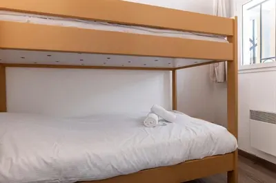 a bunk bed with two towels on top of it at Family Sea view with pools near shops and beaches in Cannes