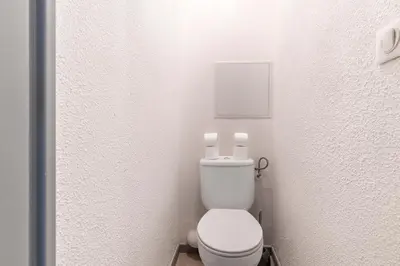 a bathroom with a white toilet in a room at Family Sea view with pools near shops and beaches in Cannes