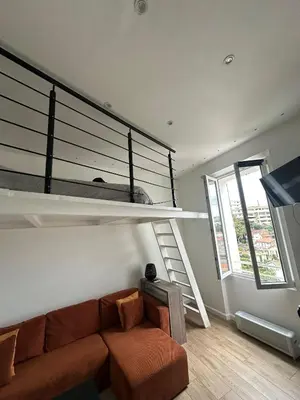 a living room with a couch and a bunk bed at Studio cosy, 8 min à pied du Palais et de la Plage in Cannes