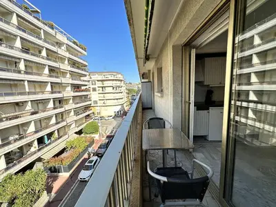 a balcony with chairs and a table on a building at Cannes proche Croisette - Studio in Cannes