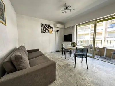a living room with a couch and a table at Cannes proche Croisette - Studio in Cannes