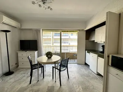 a kitchen with a table and chairs in a room at Cannes proche Croisette - Studio in Cannes
