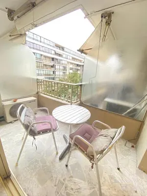 a balcony with two chairs and a table and a window at Cannes proche Croisette - Studio in Cannes