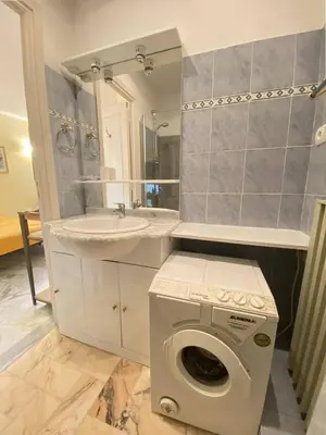 a bathroom with a washing machine and a sink at Cannes proche Croisette - Studio in Cannes
