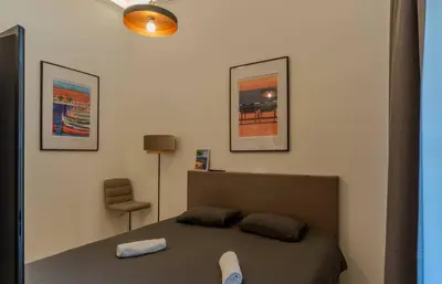 a bedroom with a bed and two pictures on the wall at Le Lac Studio Moderne Proche Suquet - climatisation Wifi - LIMESTAY in Cannes