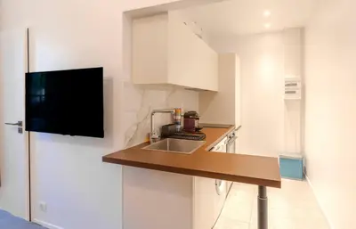 a kitchen with a sink and a counter top at Le Lac Studio Moderne Proche Suquet - climatisation Wifi - LIMESTAY in Cannes