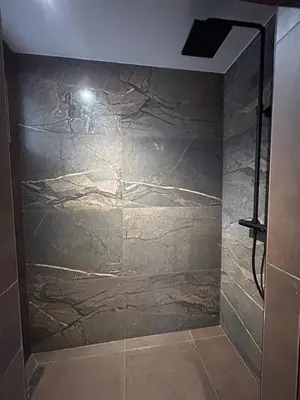 a shower in a bathroom with a stone wall at Le Lac Studio Moderne Proche Suquet - climatisation Wifi - LIMESTAY in Cannes