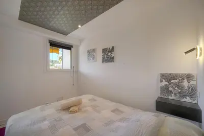 a bedroom with a bed in a white room at Isa - Clim - WiFi - Balcon - VCA in Le Cannet