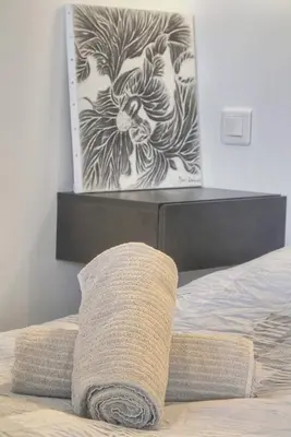a bed with a black and white painting on the wall at Isa - Clim - WiFi - Balcon - VCA in Le Cannet