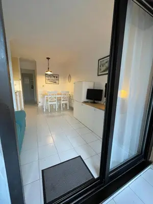a view of a living room and a dining room at Appartement Cannes, Piscine - Terrasse, Jardin Privatif - 4 Personnes in Cannes
