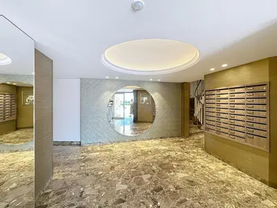 a hallway with a large circular mirror in the ceiling at Beachfront 2-bedroom apartment with balcony in Cannes