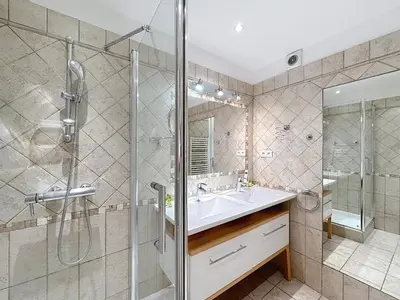a bathroom with a sink and a shower at Beachfront 2-bedroom apartment with balcony in Cannes