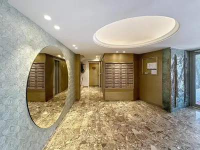 a hallway with a round mirror on the wall at Beachfront 2-bedroom apartment with balcony in Cannes