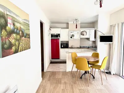a kitchen and dining room with a table and chairs at Positive in Cannes