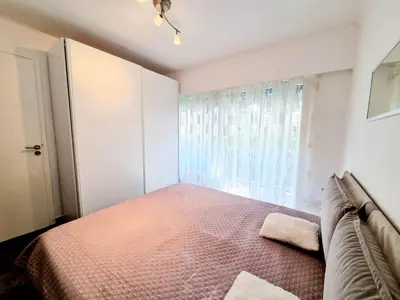 a bedroom with a bed and a window at Positive in Cannes