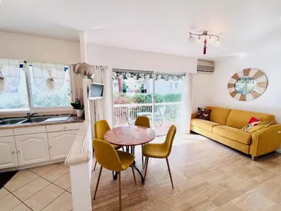 a kitchen and living room with a table and a couch at Positive in Cannes