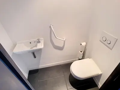 a bathroom with a toilet and a sink at 1-bedroom beachfront apartment with sea view in Cannes