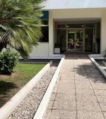 a building with a palm tree in front of it at Studio Moderne Cannes - Parking - Proche de la plage in Cannes