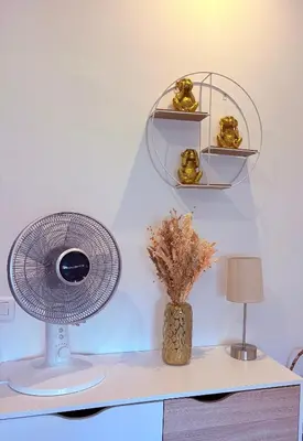 a white desk with a fan and a vase with flowers at Studio Moderne Cannes - Parking - Proche de la plage in Cannes