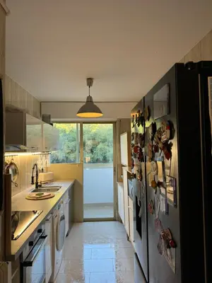 a kitchen with a refrigerator with magnets on it at Chic 2 bedroom with Huge Terrace and Pool Cannes in Cannes
