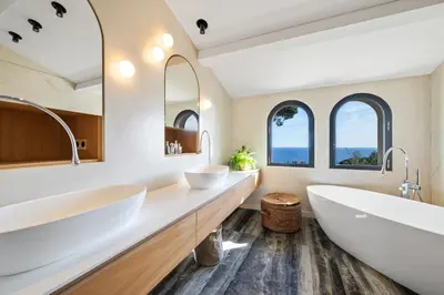 two sinks in a bathroom with two mirrors at Villa Grand Largue - vue mer 180° in Cannes