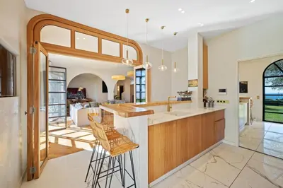 a kitchen with a bar and a living room at Villa Grand Largue - vue mer 180° in Cannes