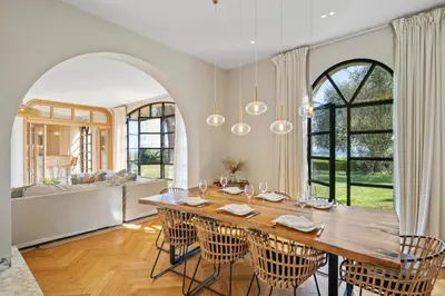 a dining room with a large table and chairs at Villa Grand Largue - vue mer 180° in Cannes