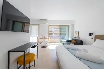 a living room with a bed and a dining room at Studio with Terrace 2 Minutes from La Croisette in Cannes