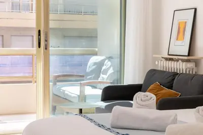 a living room with a couch and a window at Studio with Terrace 2 Minutes from La Croisette in Cannes
