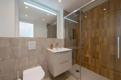 a bathroom with a toilet and a sink and a shower at Studio with Terrace 2 Minutes from La Croisette in Cannes