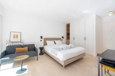 a bedroom with a bed and a couch at Studio with Terrace 2 Minutes from La Croisette in Cannes