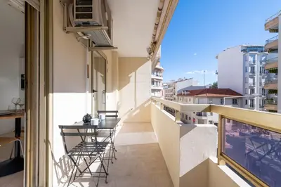 a balcony with chairs and a table on a building at Studio with Terrace 2 Minutes from La Croisette in Cannes