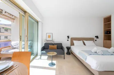a bedroom with a bed and a couch and a table at Studio with Terrace 2 Minutes from La Croisette in Cannes