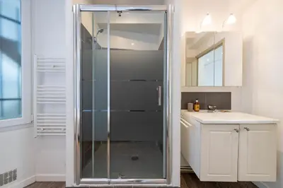 a glass shower in a bathroom with a sink at 1-Br Apartment in Cannes Walk to the Beach in Cannes