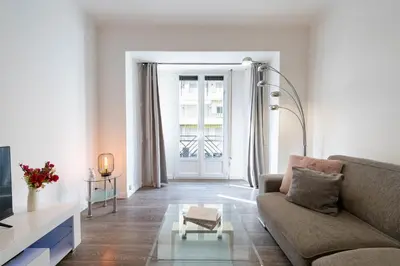 a living room with a couch and a table at 1-Br Apartment in Cannes Walk to the Beach in Cannes