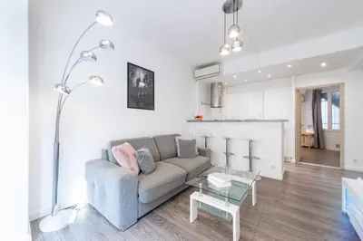 a living room with a couch and a table at 1-Br Apartment in Cannes Walk to the Beach in Cannes