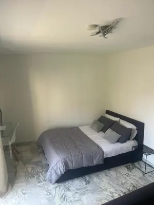 a bedroom with a bed with a ceiling fan at Studio meublé, les tambourins in Cannes